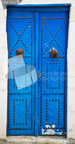 Image of Blue aged door with ornament from Sidi Bou Said in Tunisia