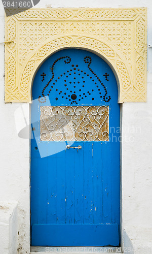 Image of Blue door with ornament and arch from Sidi Bou Said in Tunisia
