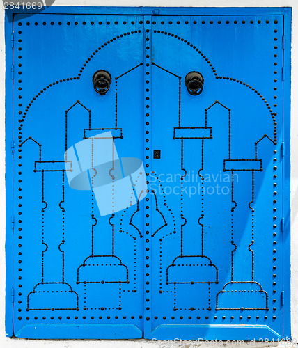 Image of Blue door with traditional ornament as symbol of Sidi Bou Said