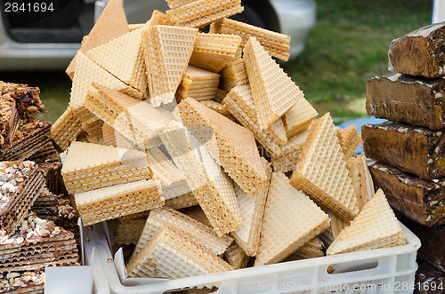 Image of layered vanilla wafer pile on stall outdoor market 