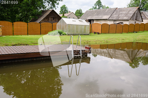 Image of garden pond with floating footbridge  