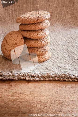 Image of Stacked Brown Cookies On Rustic Background