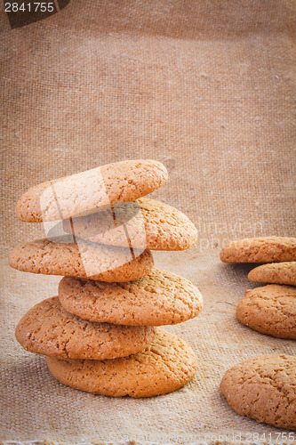 Image of Stacked Brown Cookies On Rustic Background