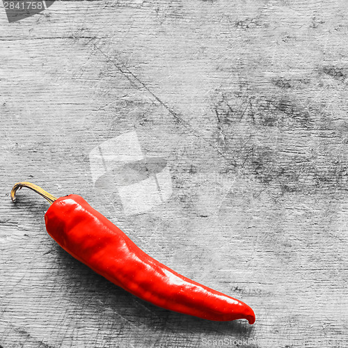 Image of Red Peppers On Old Wooden Table