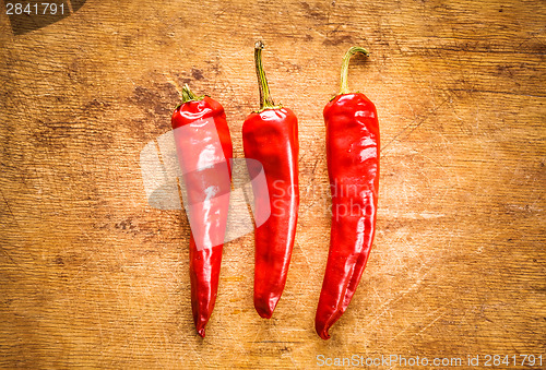 Image of Red Peppers On Old Wooden Table