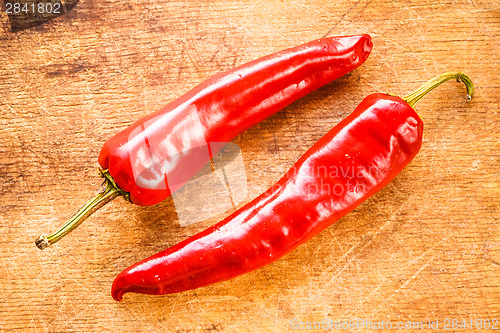 Image of Red Peppers On Old Wooden Table