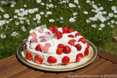 Image of Homemade cake with cream and strawberries