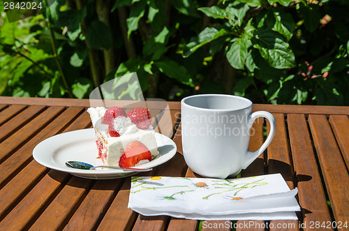 Image of Piece of strawberry cake at a table