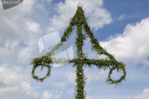 Image of Top of a midsummer pole at sky with white clouds