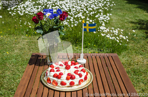 Image of Table with strawberry cake and decorations