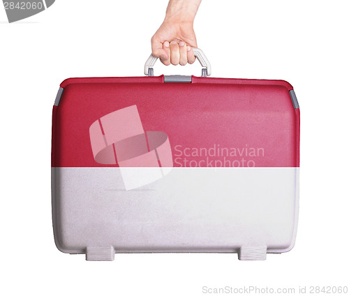 Image of Used plastic suitcase with stains and scratches