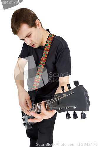 Image of Young man with electric guitar isolated on white background. Per