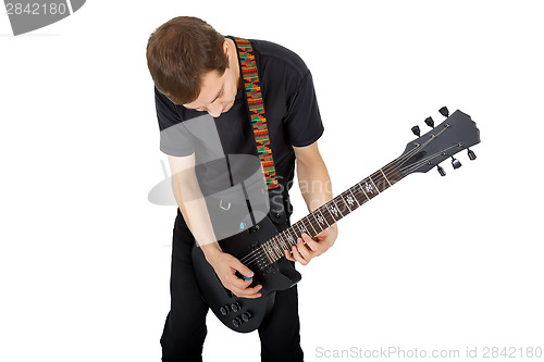 Image of Young man with electric guitar isolated on white background. Per