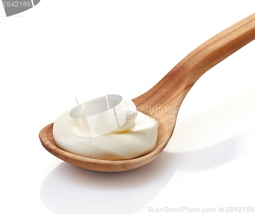 Image of cream in a wooden spoon