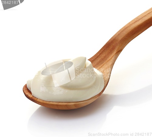 Image of cream in a wooden spoon