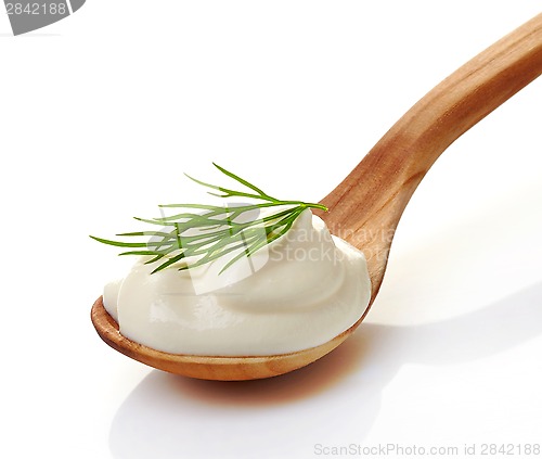 Image of cream in a wooden spoon
