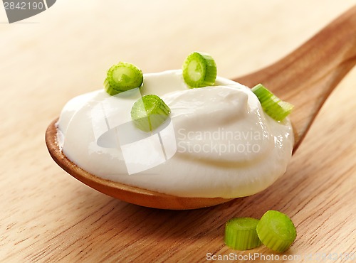 Image of cream in a wooden spoon