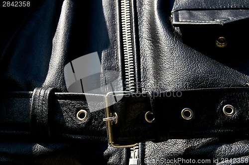 Image of black leather biker jacket belt zipper and pocket