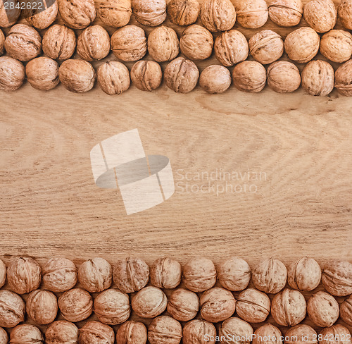 Image of Unshelled Walnuts Lying On Desk