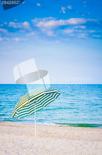 Image of White striped umbrella on beach