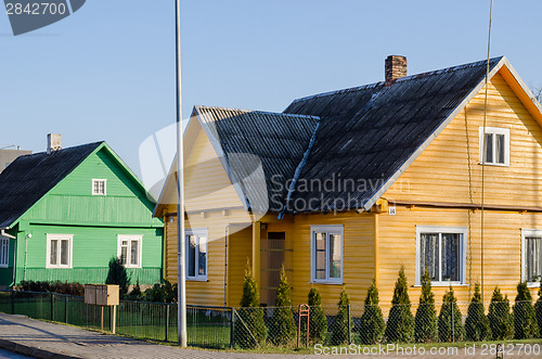 Image of rural green yellow painted houses along street 