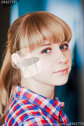 Image of Close up portrait of a smiling young woman looking at camera
