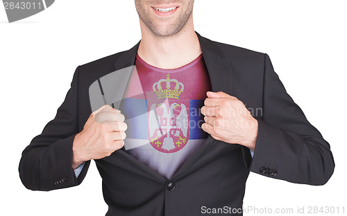 Image of Businessman opening suit to reveal shirt with flag