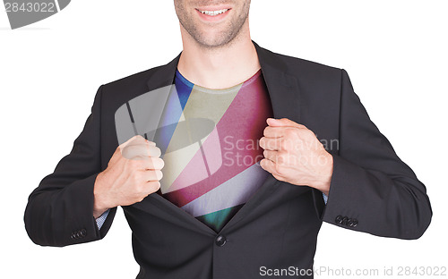 Image of Businessman opening suit to reveal shirt with flag