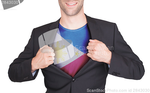 Image of Businessman opening suit to reveal shirt with flag