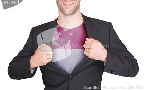 Image of Businessman opening suit to reveal shirt with flag