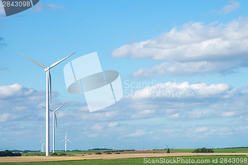 Image of Wind generator turbine on summer landscape