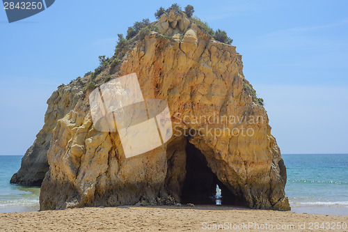 Image of Rock with cave in the ocean