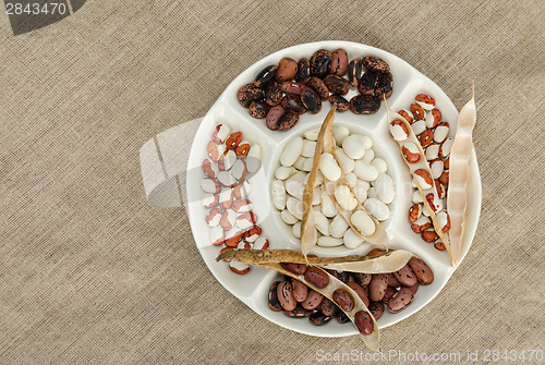 Image of colorful bean in plate on linen texture background 