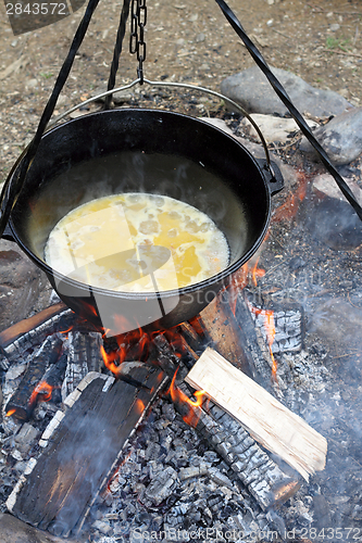 Image of making food on camp fire