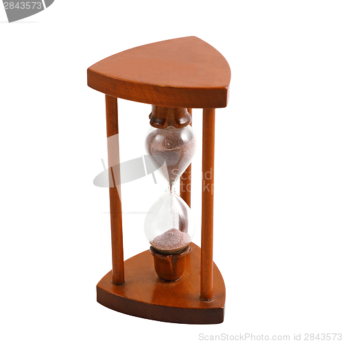 Image of ancient wooden hourglass over white