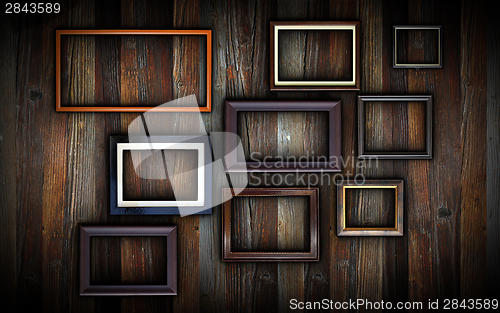 Image of frames on dark wooden wall