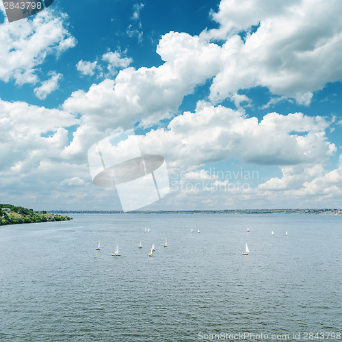 Image of river with white yachts and cloudy sky