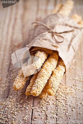 Image of bread sticks grissini with sesame seeds in craft pack