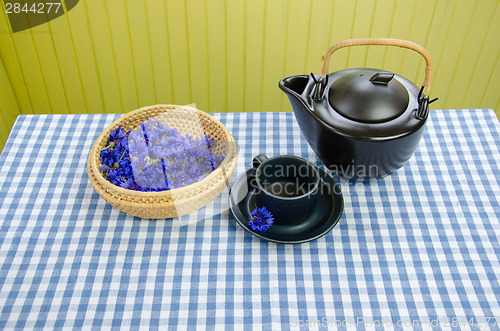 Image of healing fresh aromatic cornflower tea set on table 