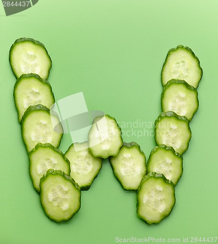 Image of W letter made of raw cucumber