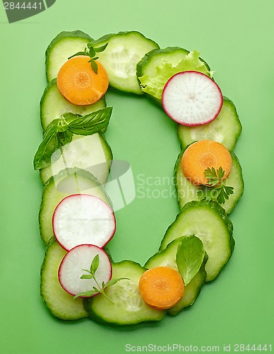 Image of D letter made of raw vegetables