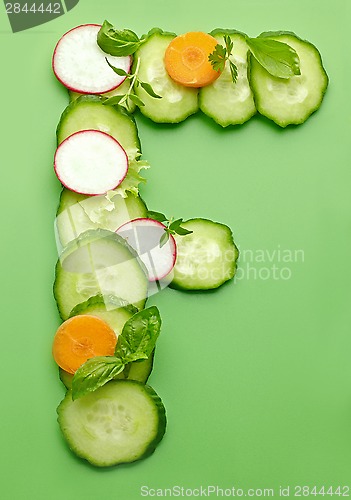 Image of F letter made of raw vegetables