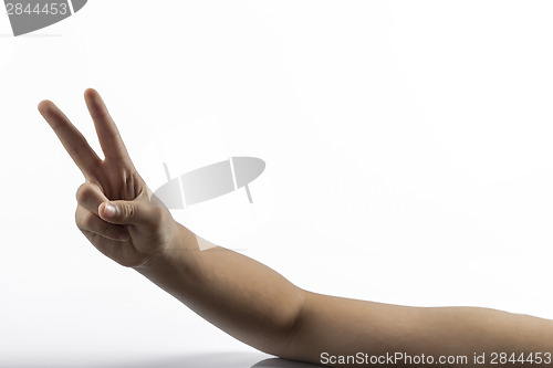 Image of Young hands making victory sign