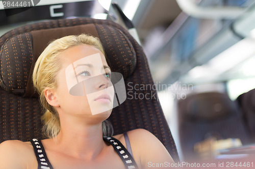 Image of Lady traveling by train.