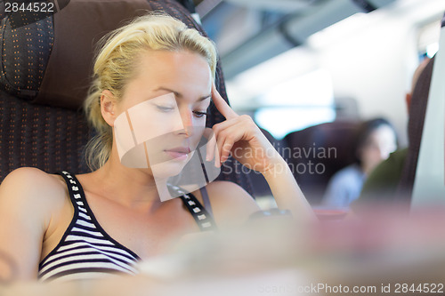 Image of Lady traveling by train.