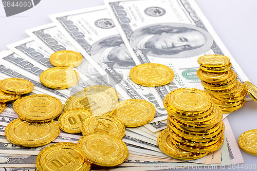 Image of Gold coins and dollar banknotes