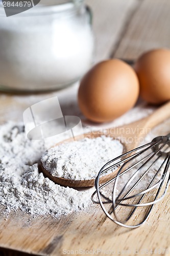 Image of flour, eggs and kitchen utensil