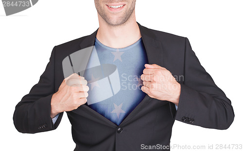 Image of Businessman opening suit to reveal shirt with flag