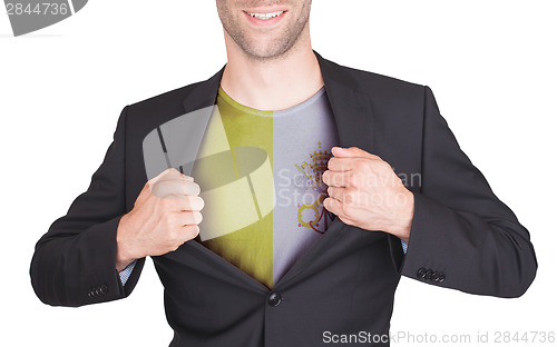 Image of Businessman opening suit to reveal shirt with flag