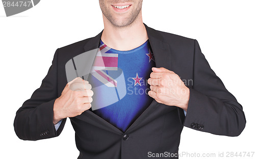 Image of Businessman opening suit to reveal shirt with flag